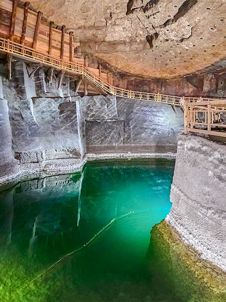 Underground lake with wooden walkways in Wieliczka Salt Mine, Poland.