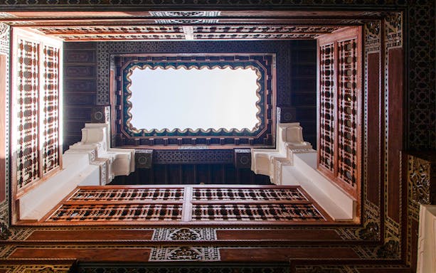 View of Ben Youssef Madrasa courtyard ceiling in Marrakesh, Morocco.