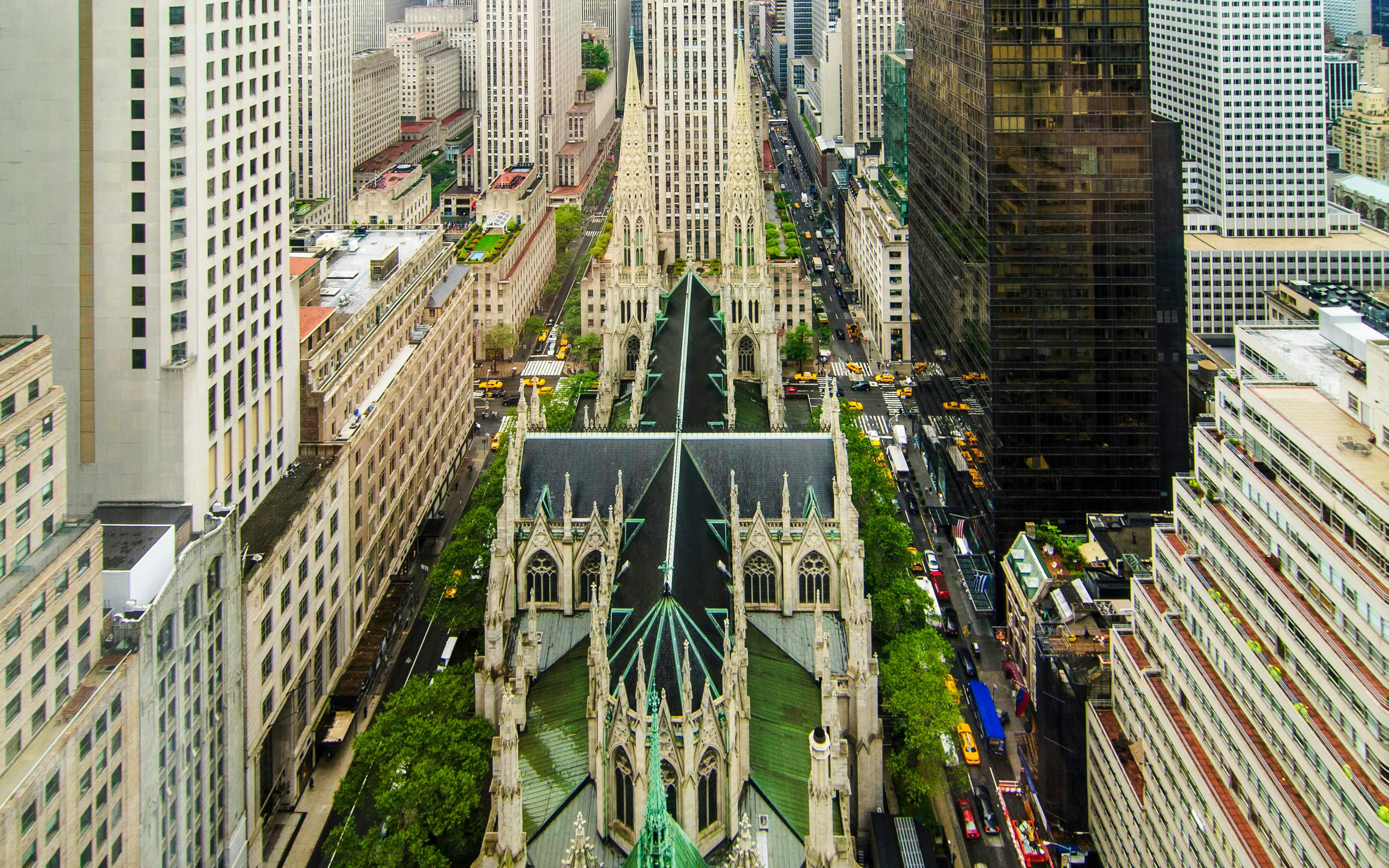 Aerial view of St. Patrick's Cathedral and surrounding skyscrapers in New York City.