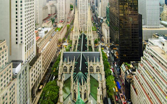 Aerial view of St. Patrick's Cathedral and surrounding skyscrapers in New York City.