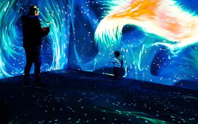 Father and child exploring Lisbon Oceanarium's Submerged Universe exhibit.
