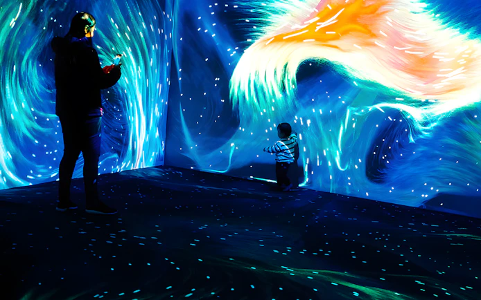 Father and child exploring Lisbon Oceanarium's Submerged Universe exhibit.