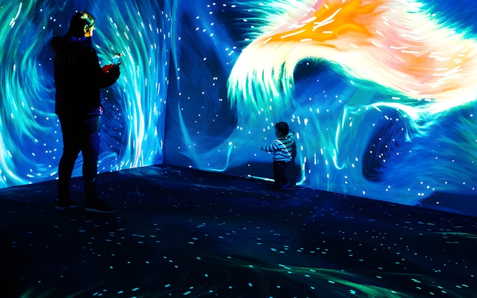 Father and child exploring Lisbon Oceanarium's Submerged Universe exhibit.