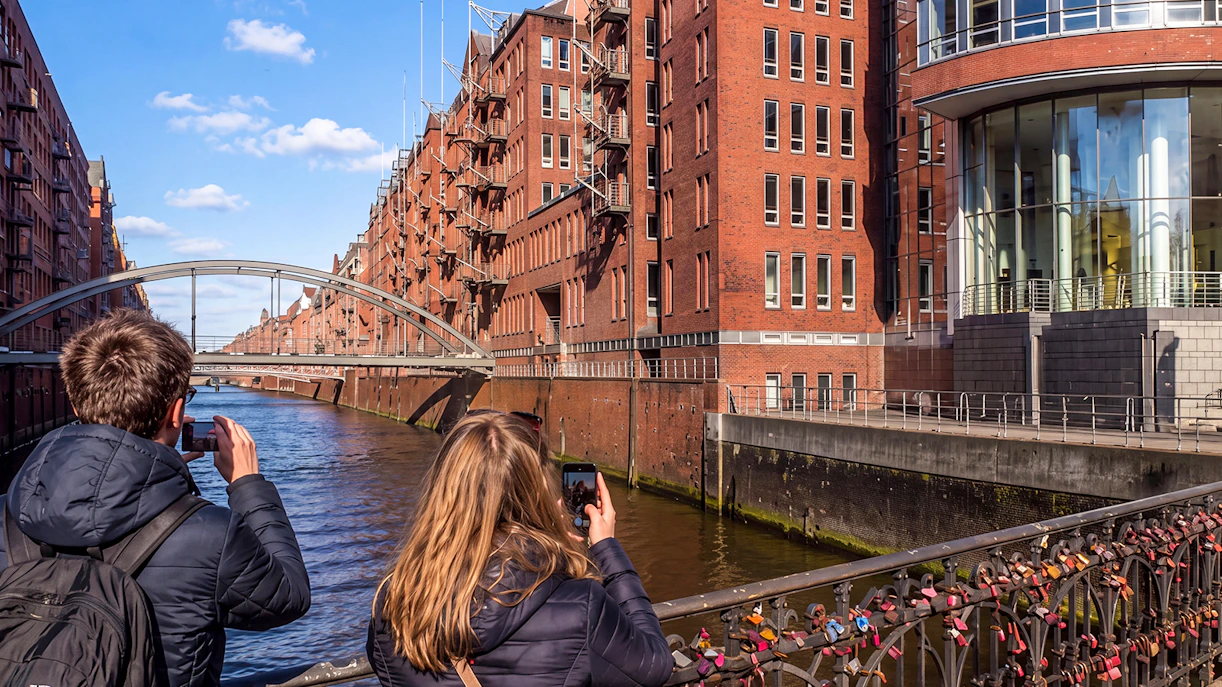 Visitors photographing Speicherstadt canal near Elbphilharmonie, Hamburg, Germany.