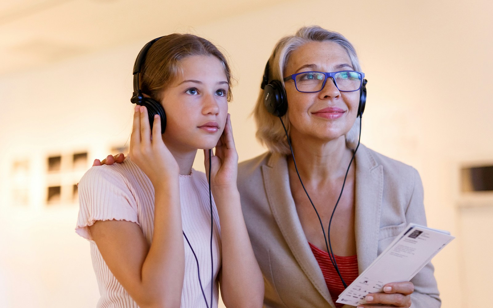 Young girl and woman using audio guide at St Paul's Cathedral, London tour.