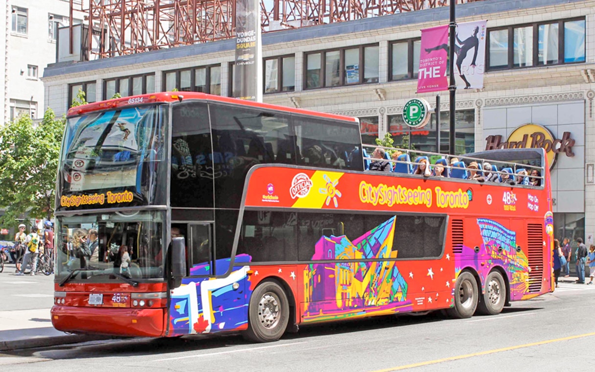 Open top Toronto Hop-On Hop-Off bus near Yonge-Dundas Square.
