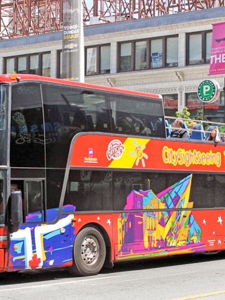 Open top Toronto Hop-On Hop-Off bus near Yonge-Dundas Square.