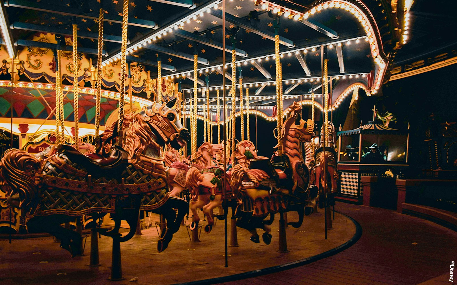 Le Carrousel de Lancelot with colorful horses in Disneyland Paris.