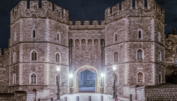 King Henry VIII Gate at Windsor Castle illuminated at night.