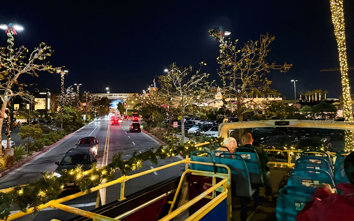 Tourists on Los Angeles HOHO bus during Holiday Lights Tour at night.