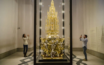 Visitors photographing the Great Monstrance of Arfe in Toledo Cathedral's museum, Spain.