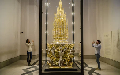 Visitors photographing the Great Monstrance of Arfe in Toledo Cathedral's museum, Spain.