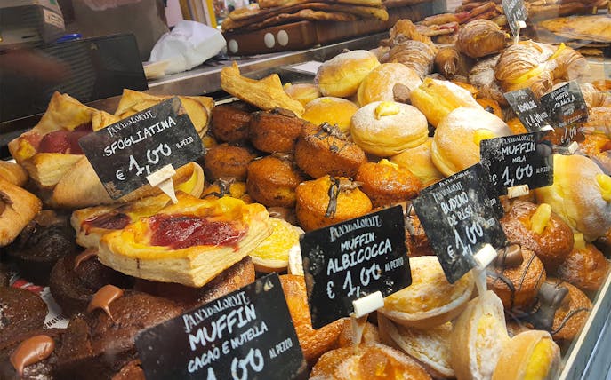 Florence bakery display with assorted pastries and price tags.