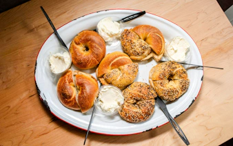 Bagels with cream cheese on a platter, part of South Lake Union street food tour.