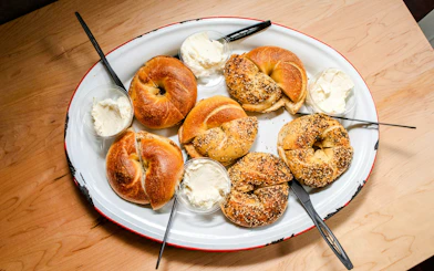 Bagels with cream cheese on a platter, part of South Lake Union street food tour.