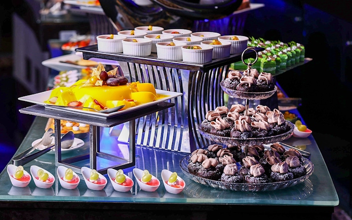 Dessert buffet with pastries and fruit at Petronas Twin Towers dining experience.