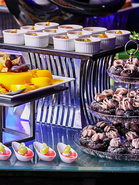 Dessert buffet with pastries and fruit at Petronas Twin Towers dining experience.