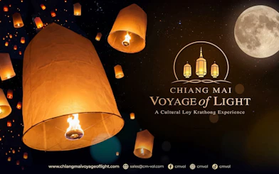 Lanterns floating in the night sky during Chiang Mai Voyage of Light festival.