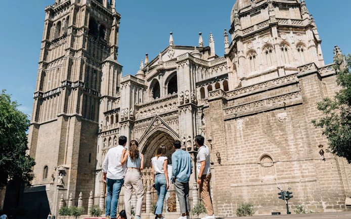 Tourists with guide at Toledo Cathedral, Spain.