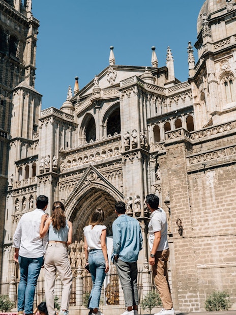 Tourists with guide at Toledo Cathedral, Spain.