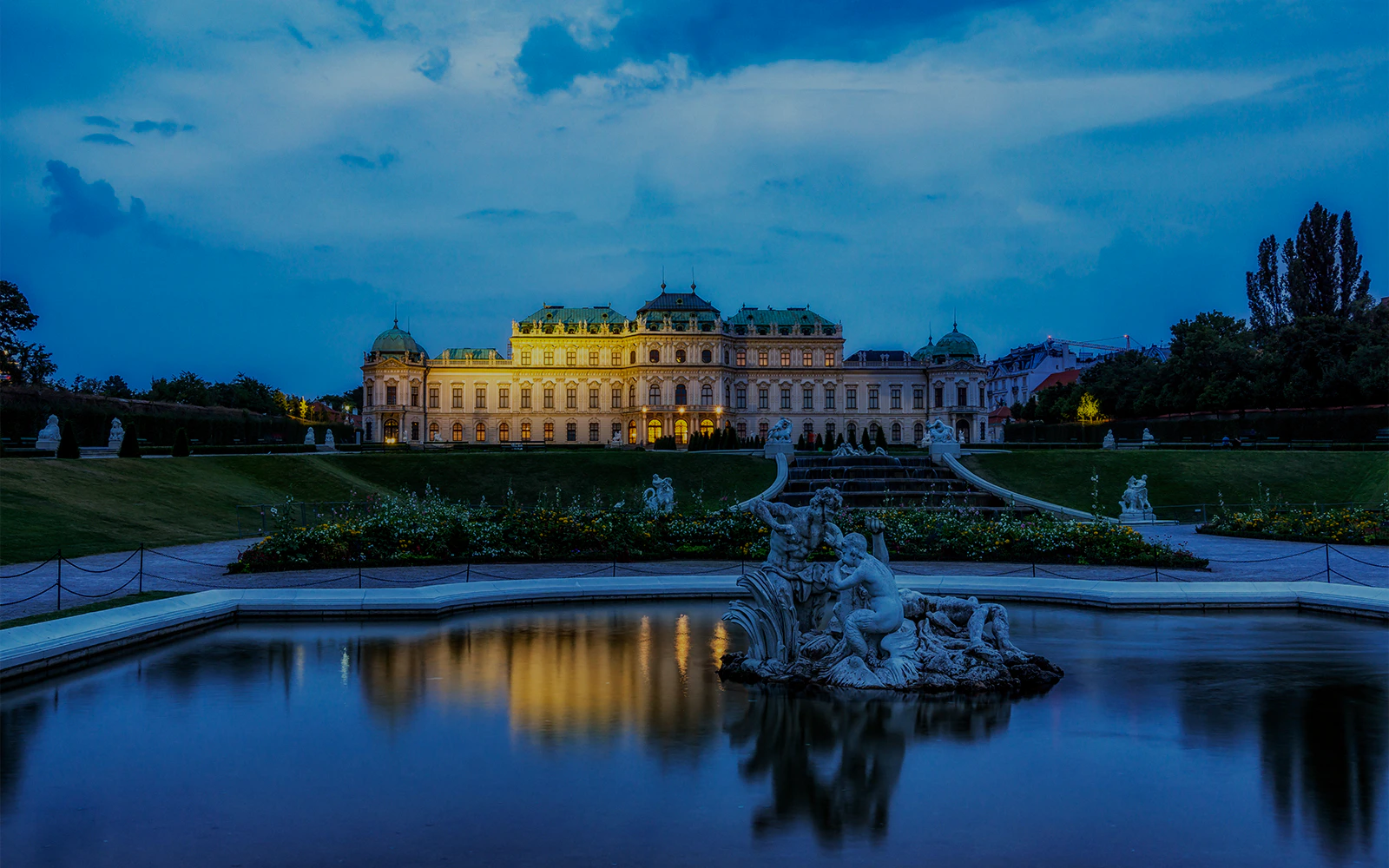 Upper Belvedere Palace reflecting in pond with garden view, Vienna, Austria.
