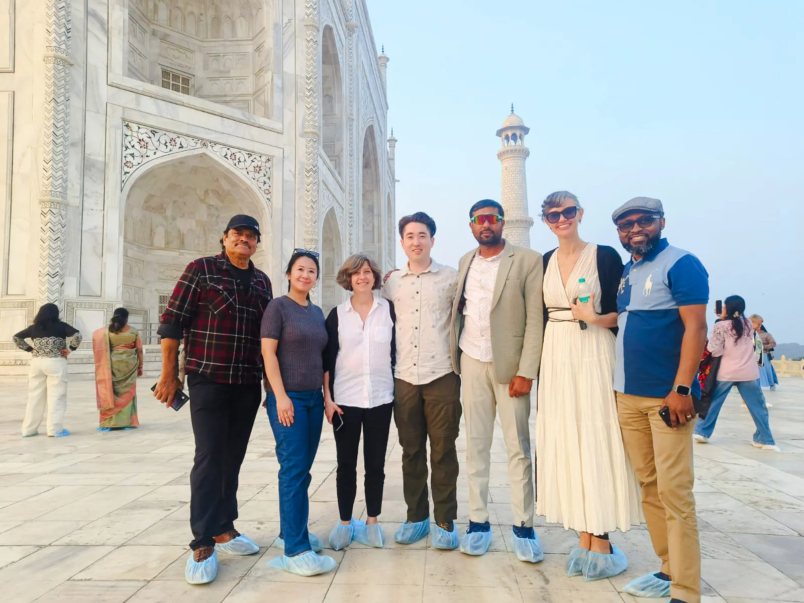 Group of tourists in front of the Taj Mahal during a guided tour in Agra.