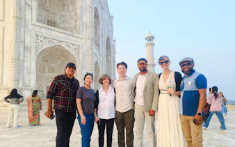 Group of tourists in front of the Taj Mahal during a guided tour in Agra.