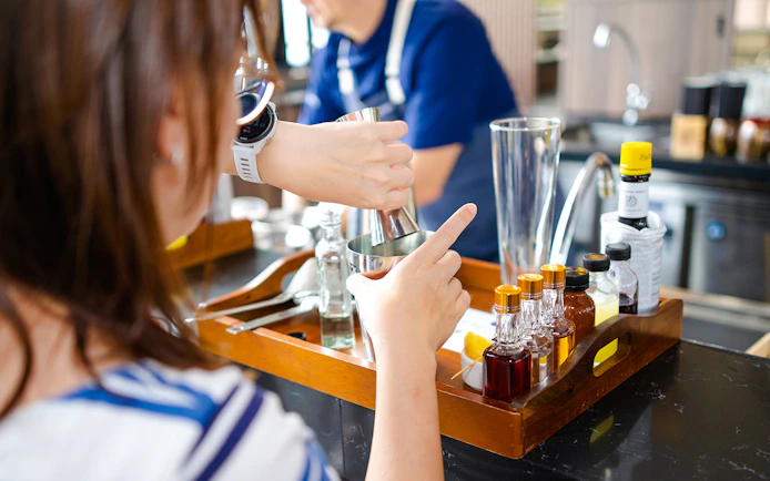 Cocktail making at Mirabilis bar with ingredients and tools, Singapore cable car tour.