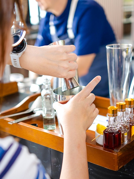 Cocktail making at Mirabilis bar with ingredients and tools, Singapore cable car tour.