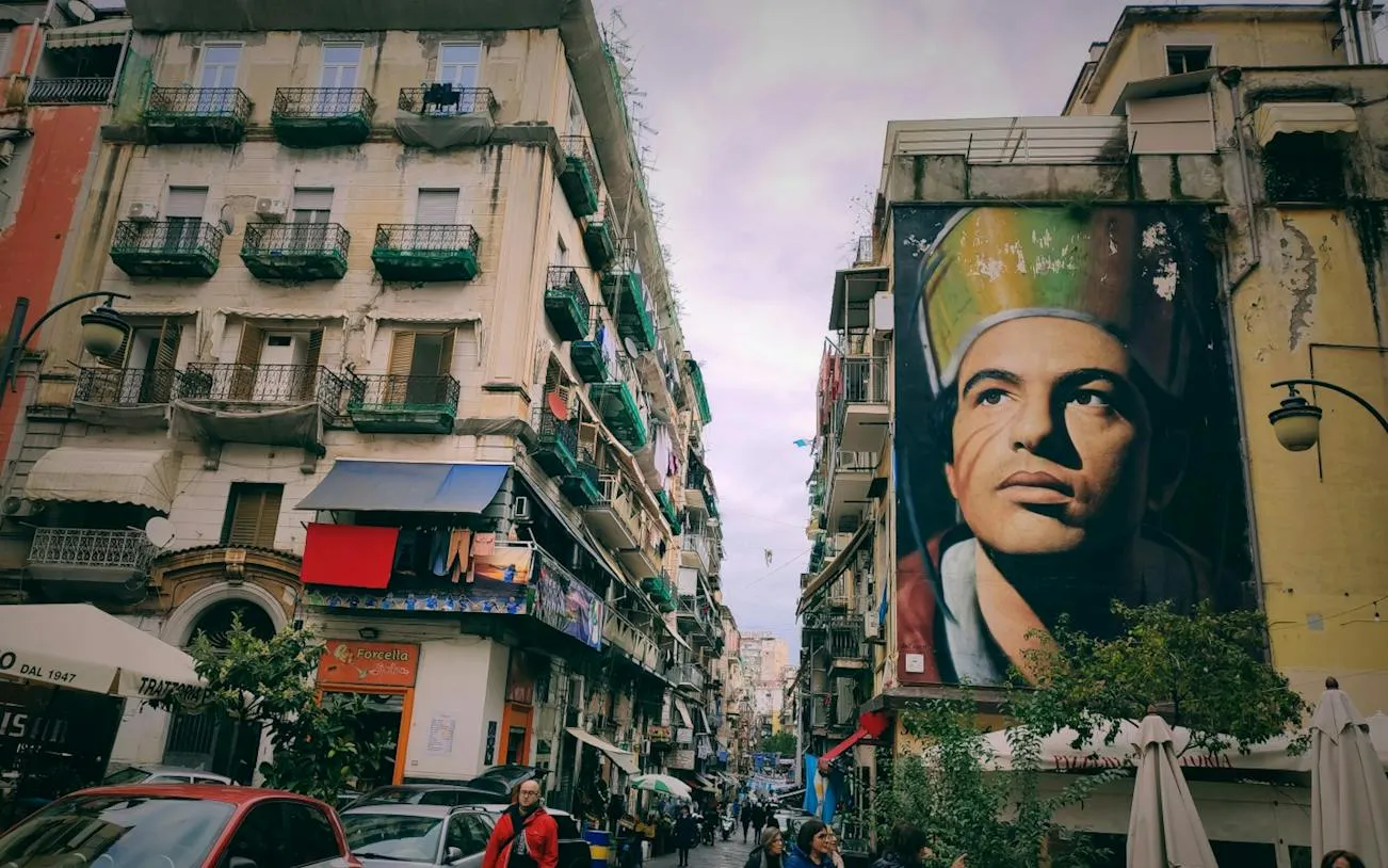 Street in Naples with large mural, part of Curse of Naples Mafia Secrets self-guided city exploration game.