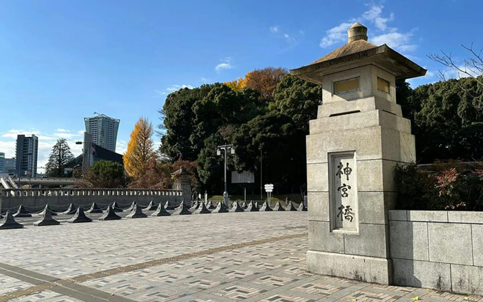 Meiji Shrine entrance with stone lantern and trees, Tokyo.