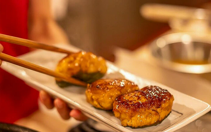 Three grilled patties on a plate during Tokyo Izakaya-style cooking class.