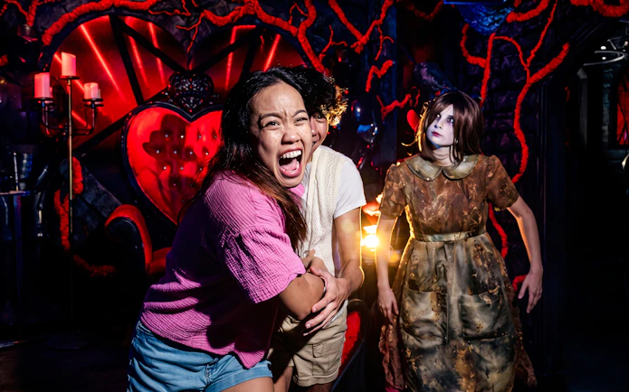 Visitors experiencing a haunted house attraction at Howl-O-Scream, Busch Gardens Tampa.