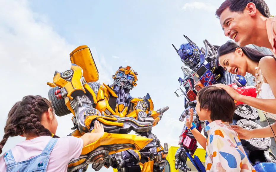 Visitors interacting with Transformers characters at Universal Studios Singapore.