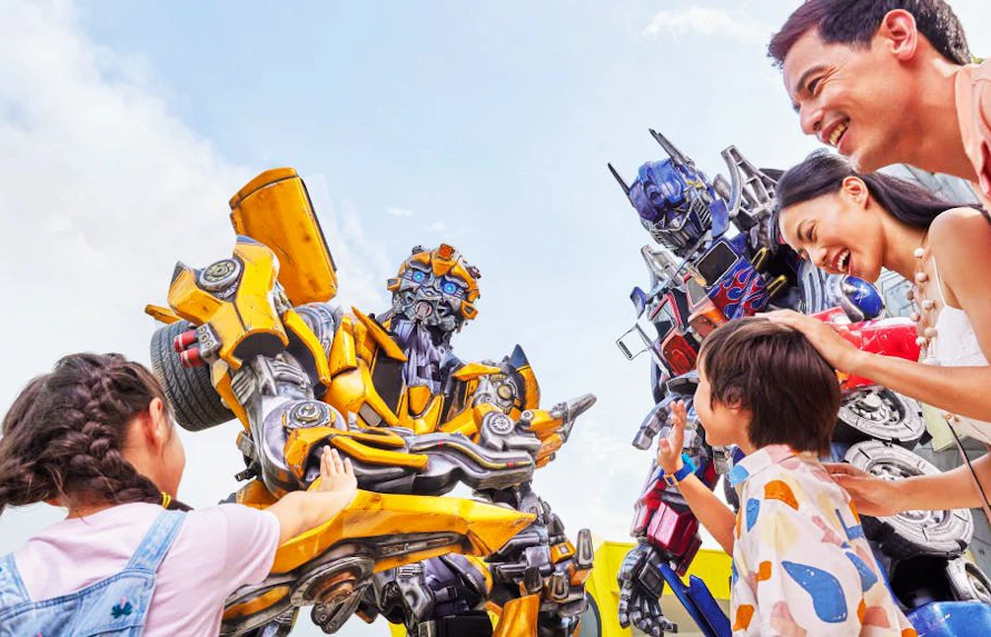 Visitors interacting with Transformers characters at Universal Studios Singapore.