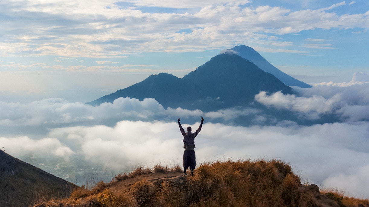 Man looking at Mount Batur on a sunrise trek