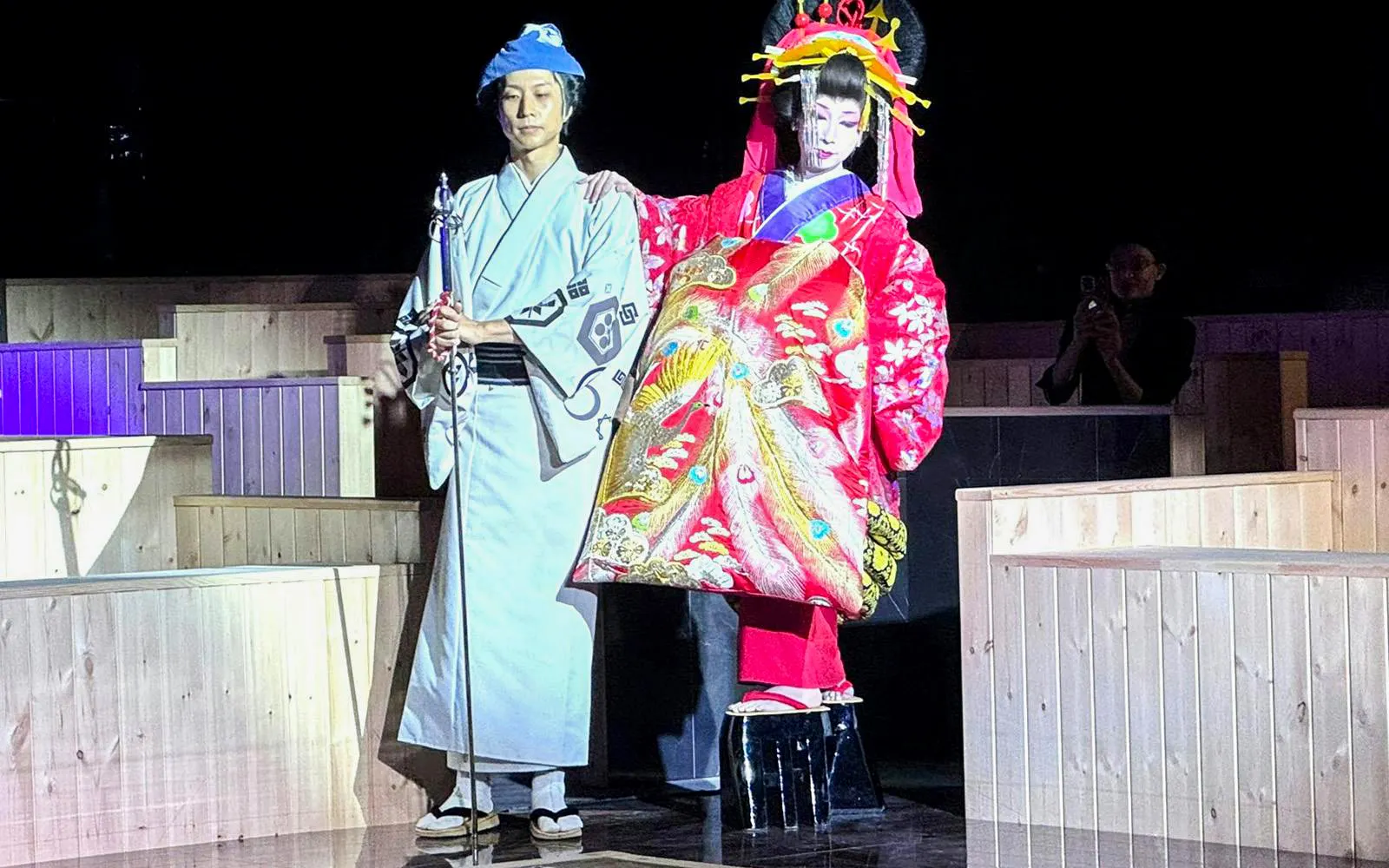 Traditional Japanese performers in colorful attire at Authentic Sumo Experience.