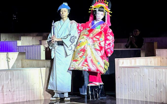 Traditional Japanese performers in colorful attire at Authentic Sumo Experience.