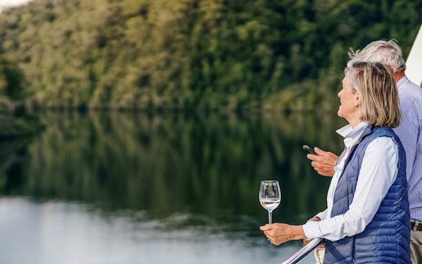 People enjoying wine on a Gordon River cruise from Strahan.