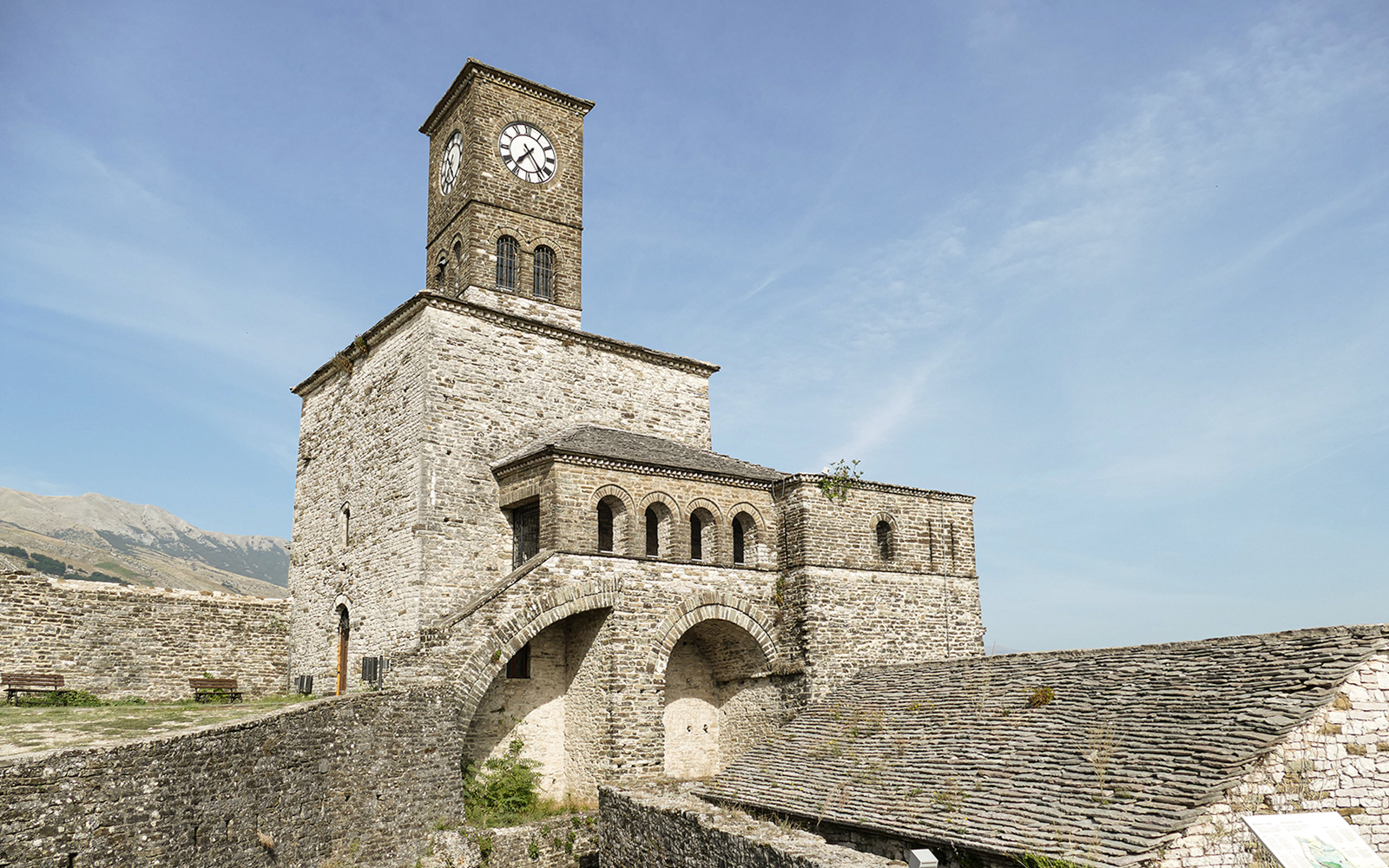 Gjirokaster Castle clock tower against a clear sky in Albania.