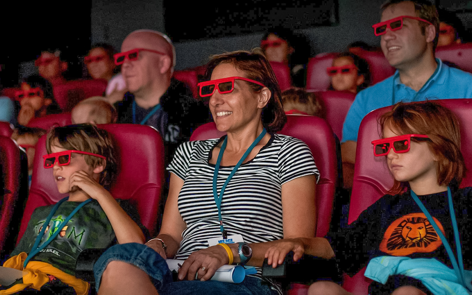 Audience wearing 3D glasses in a 4D theater experience.