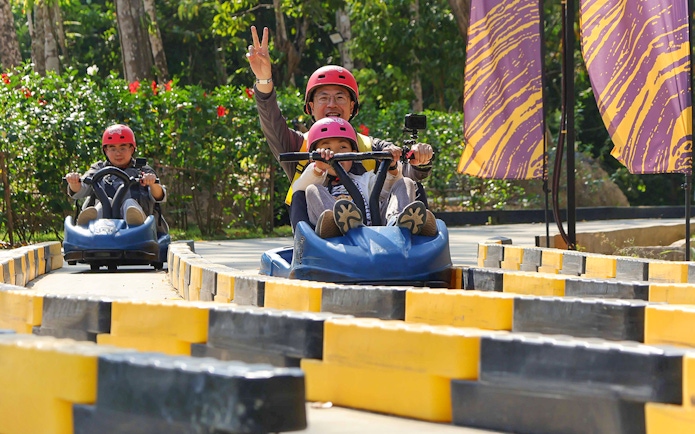 Zipline participants enjoying a go-kart ride at Hanuman World, Thailand.