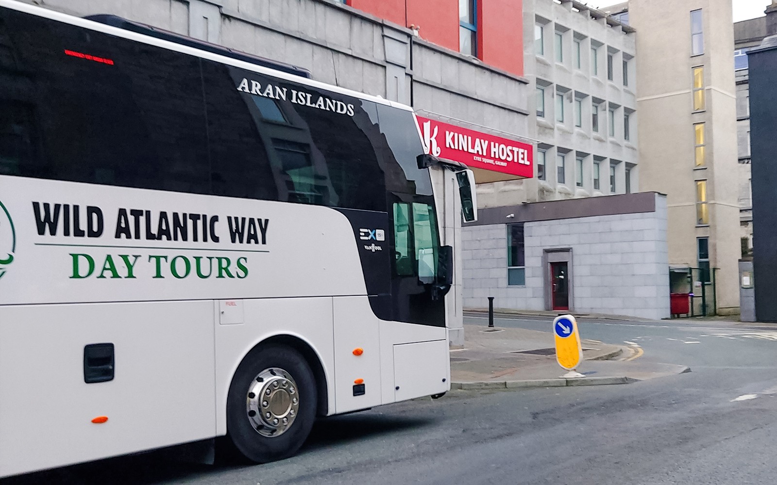 Bus parked near Kinlay Hostel for Wild Atlantic Way day tours in Galway.
