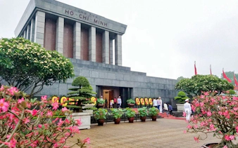 Ho Chi Minh Mausoleum with visitors and gardens, part of Hanoi City Tour.