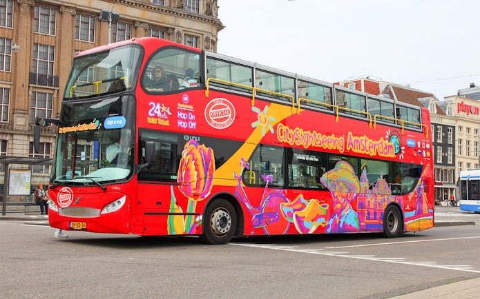 City Sightseeing hop on hop off bus in Amsterdam with colorful design.