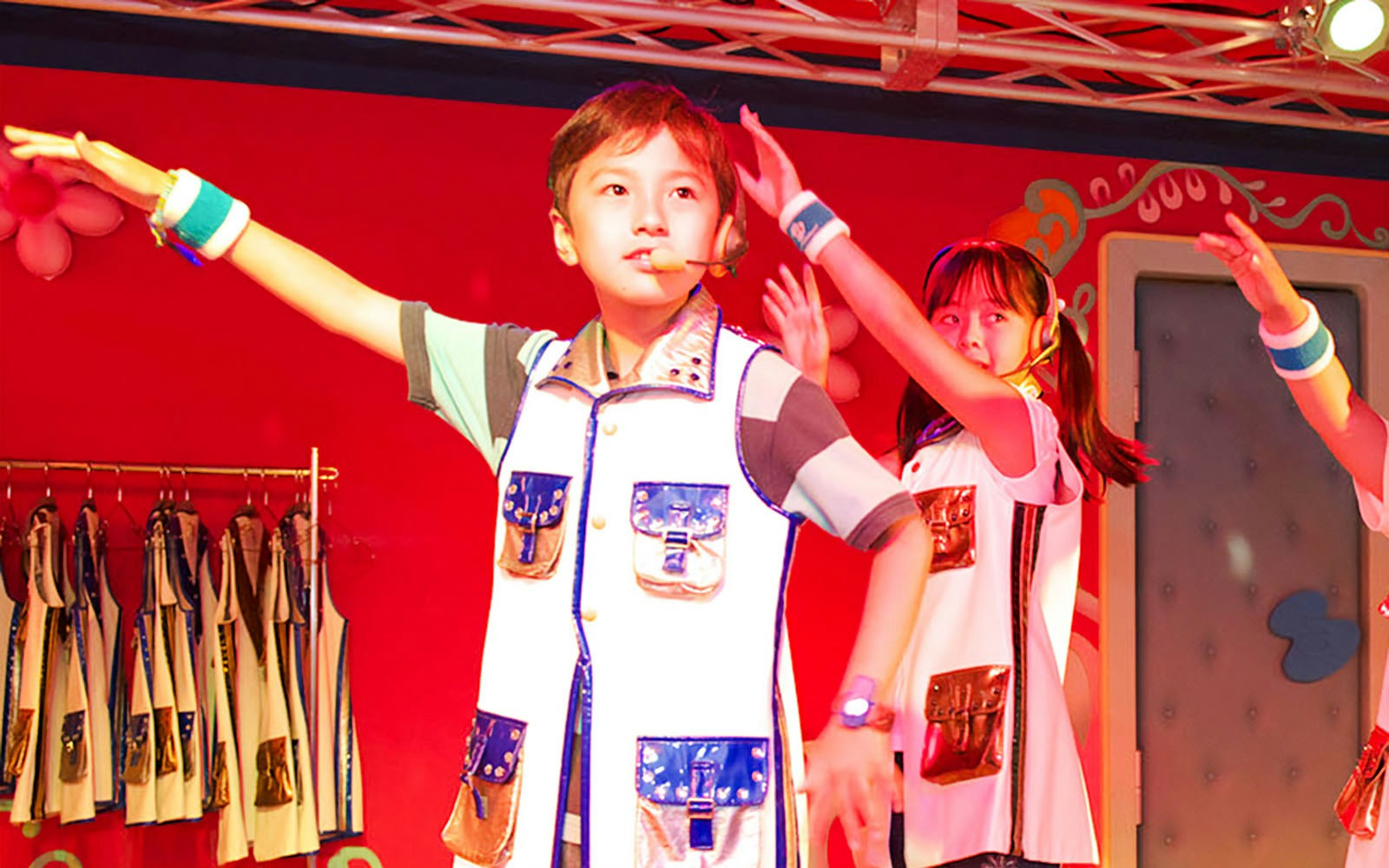 Children performing on stage at KidZania Singapore school program.