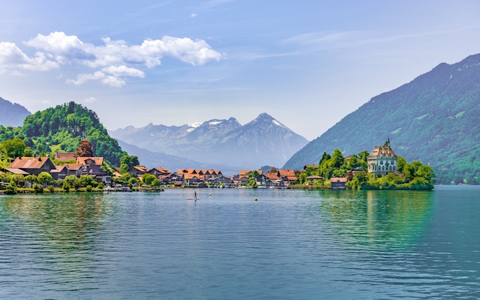 Fishing village of Iseltwald on Lake Brienz with mountains in the background, Switzerland.