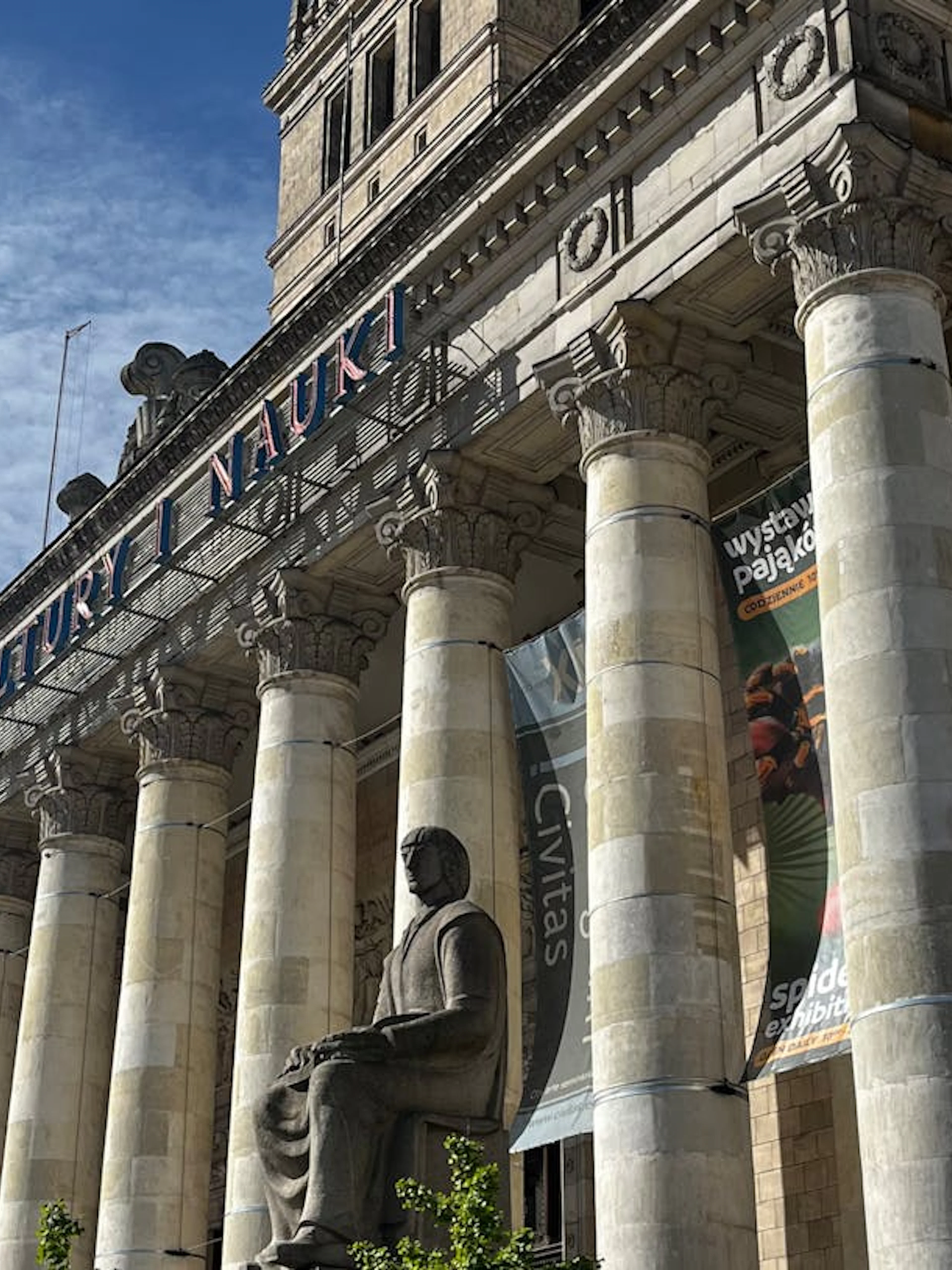 Palace of Culture and Science facade with columns and statue in Warsaw.