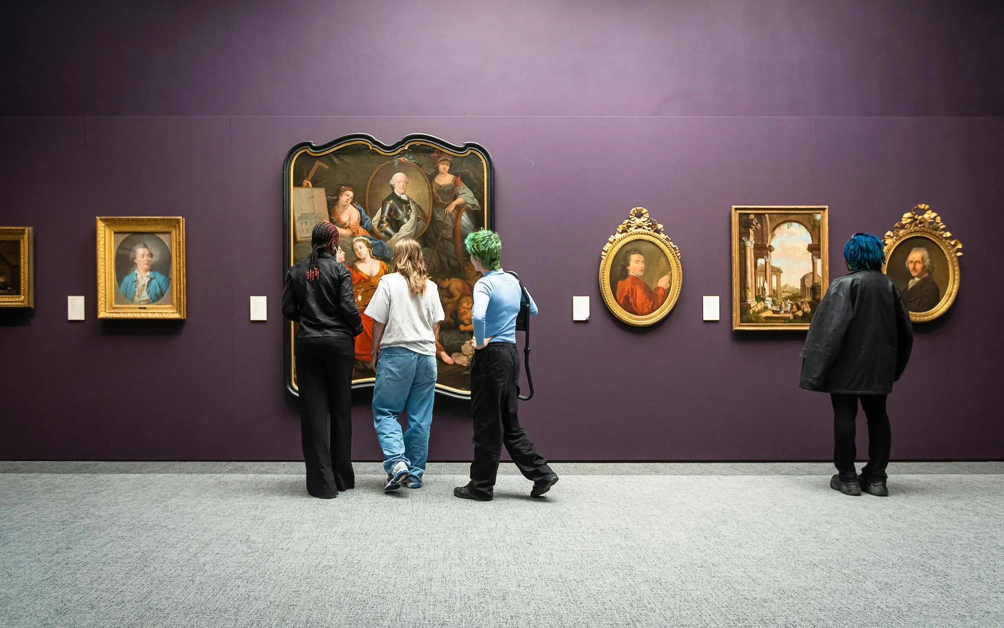 Visitors viewing classic paintings at Groeningemuseum, Bruges.