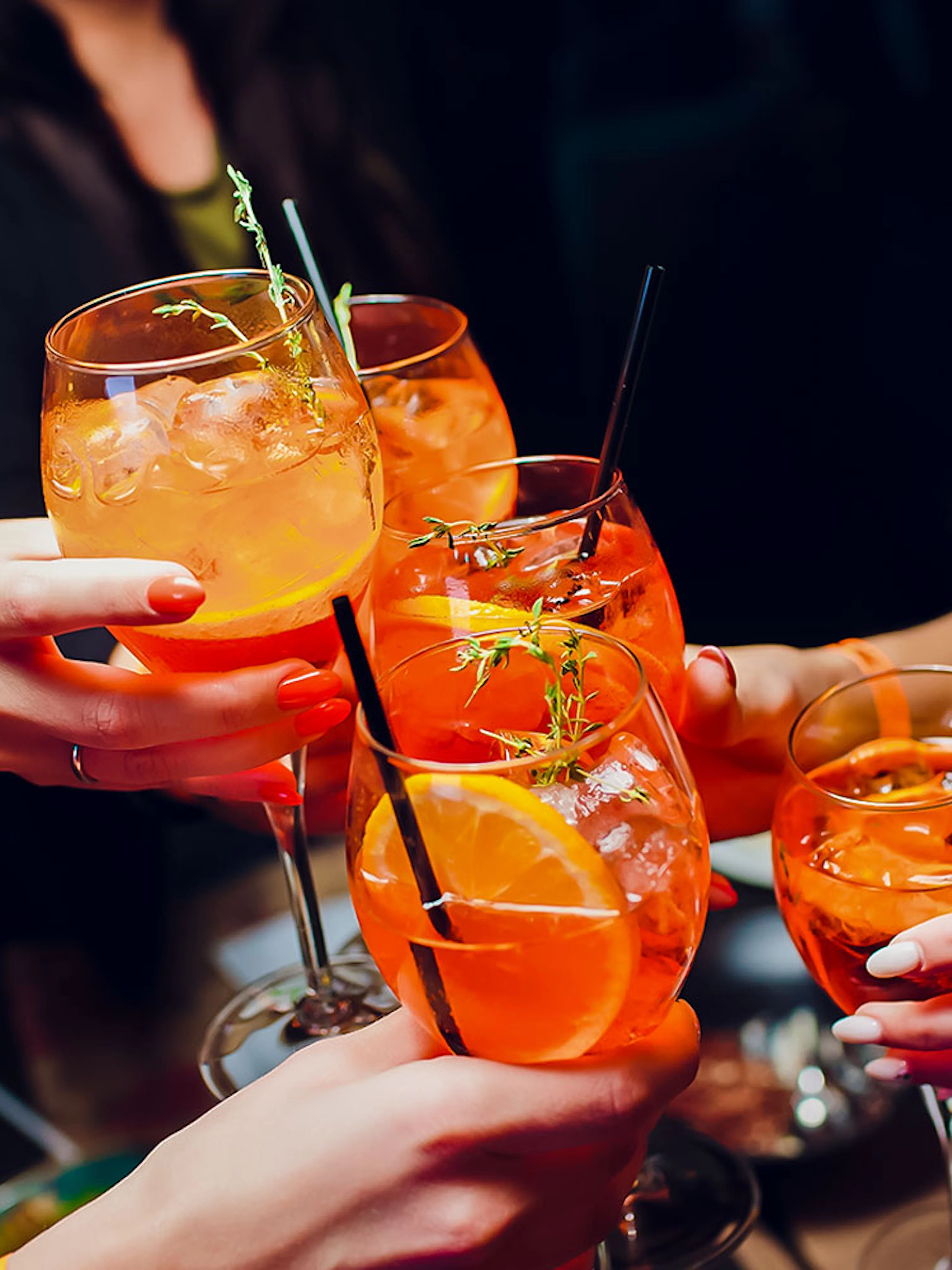 People toasting with Aperol Spritz at Illy Caffè, St. Mark's Square, Venice.